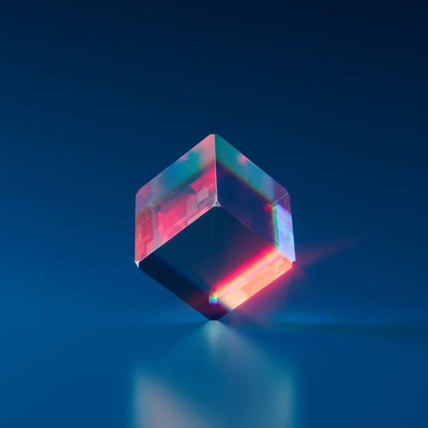 A cube in the center with blue and red colors, being supported by one of its corners.